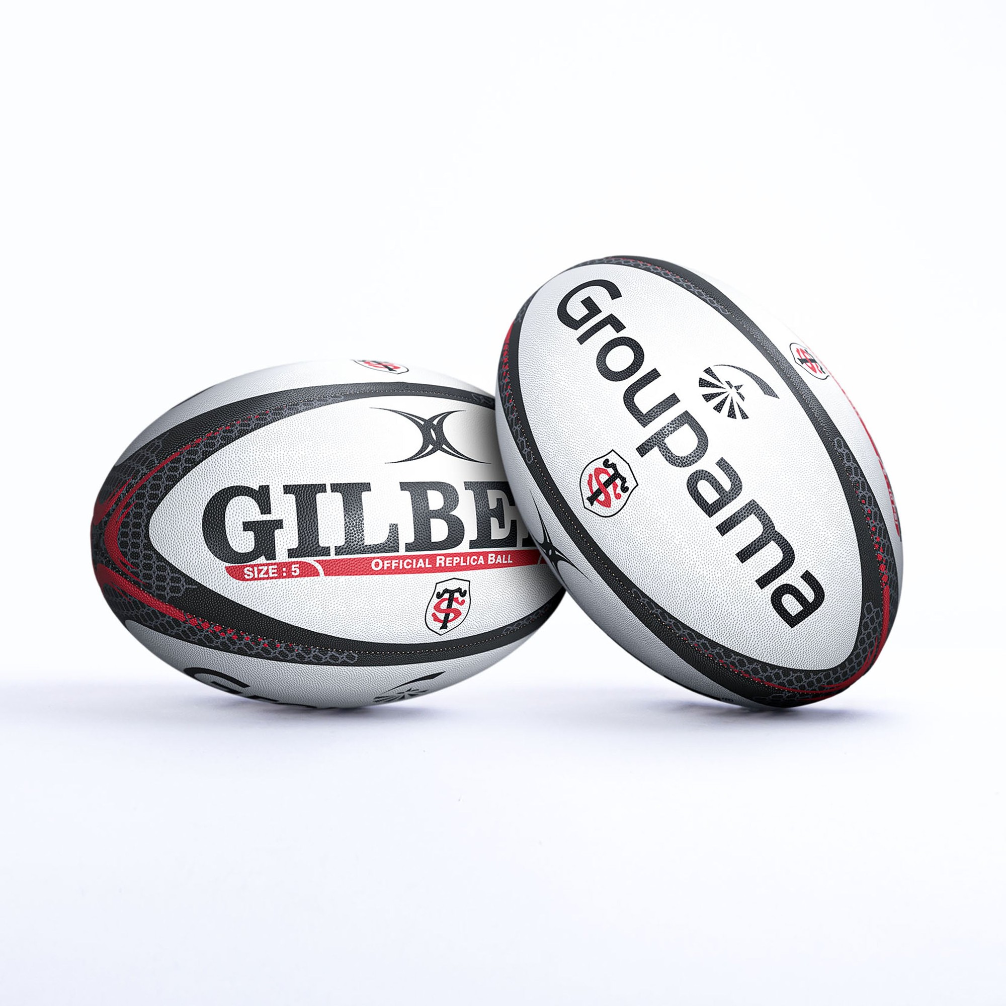 White rugby ball featuring red and black accents, with "GILBERT" and "Groupama" logos prominently displayed, designed as a replica of the Stade Toulousain team ball.