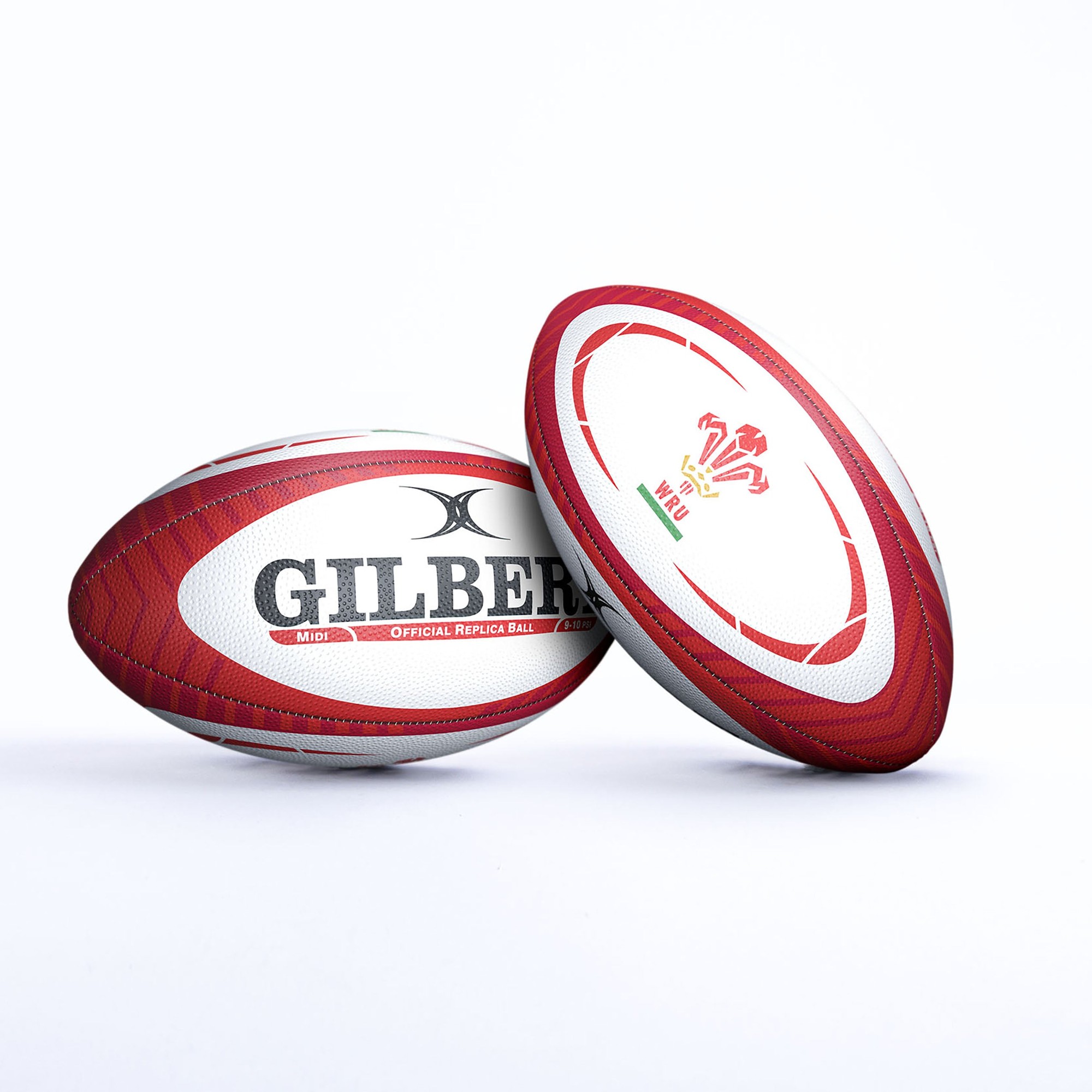 Gilbert Wales replica rugby ball in red and white, featuring the Welsh dragon emblem and "GILBERT" branding, made of durable synthetic material.