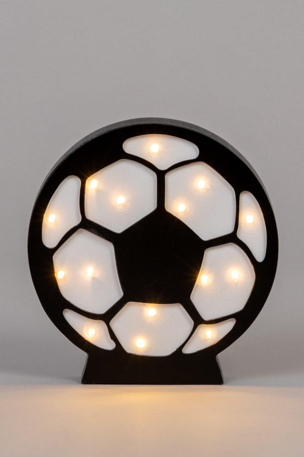 White football-shaped table lamp featuring a black outline and illuminated hexagonal patterns, designed for kids' rooms, with soft, warm LED lights.
