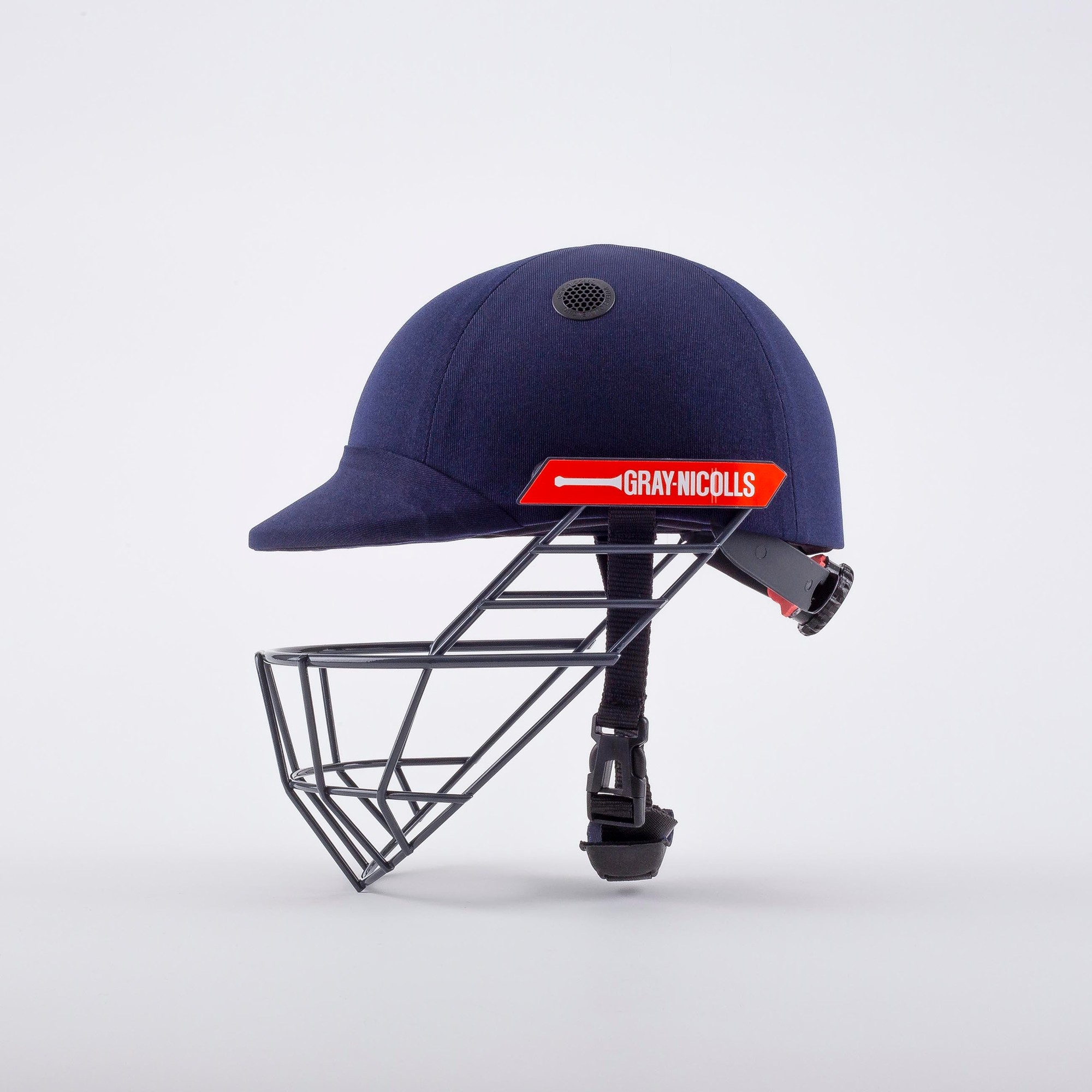 Gray-Nicolls Atomic Cricket Helmet in black with a sturdy metal grille, adjustable chin strap, and ventilation holes for comfort and safety during play.