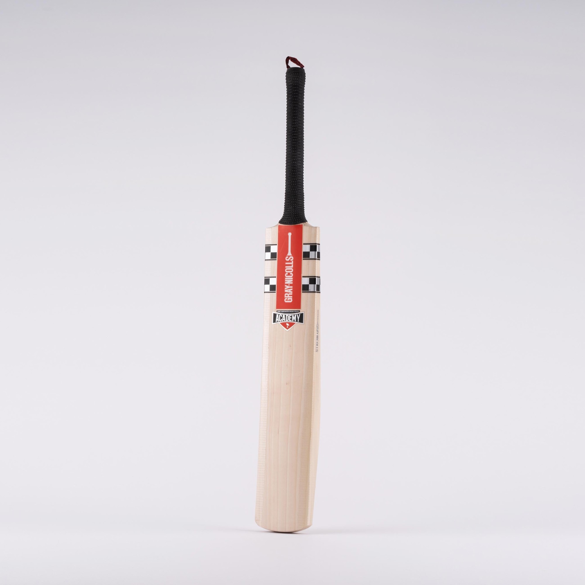 Gray-Nicolls Classic Academy Infant Junior Cricket Bat in black and white, featuring a smooth wooden blade, textured black grip, and a striking red and white label design.