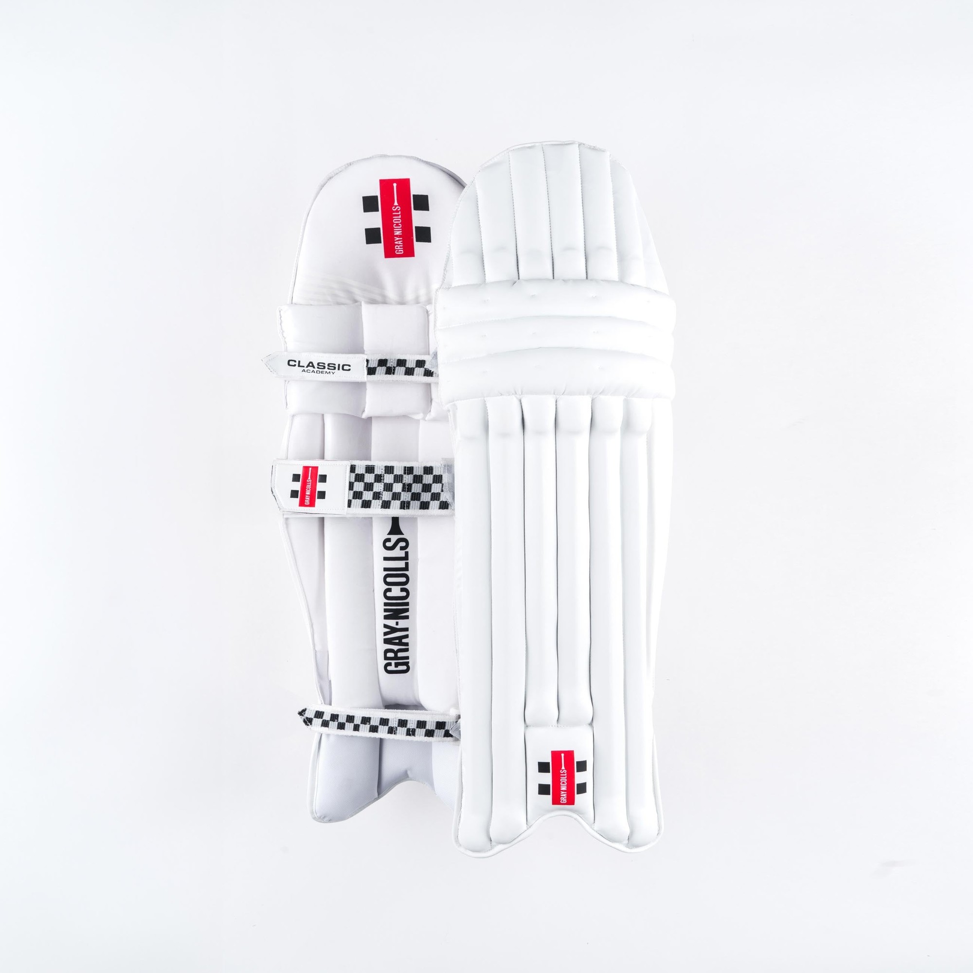 White Gray-Nicolls Classic Academy cricket pads featuring a sleek design, padded protection, adjustable straps, and a distinctive black and red logo.