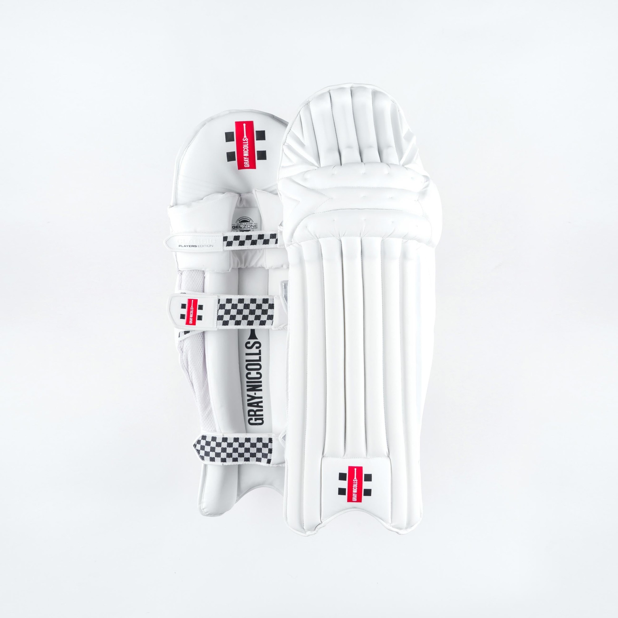 Gray-Nicolls Classic Players Edition batting pads in white, featuring a sleek design with padded protection, adjustable straps, and a checkered pattern along the edges.