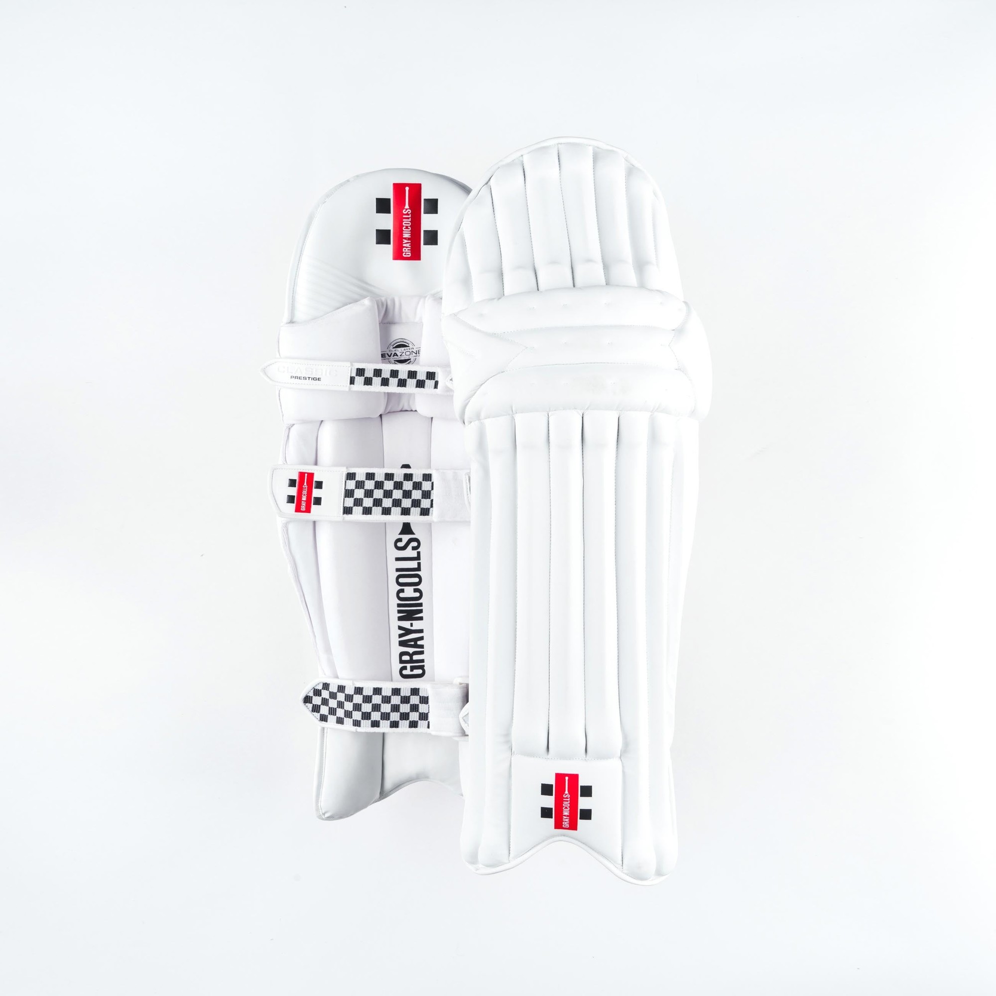 Gray-Nicolls Classic Prestige batting pads in white with multicolour accents, featuring padded protection, vertical grooves, and adjustable straps for a secure fit.