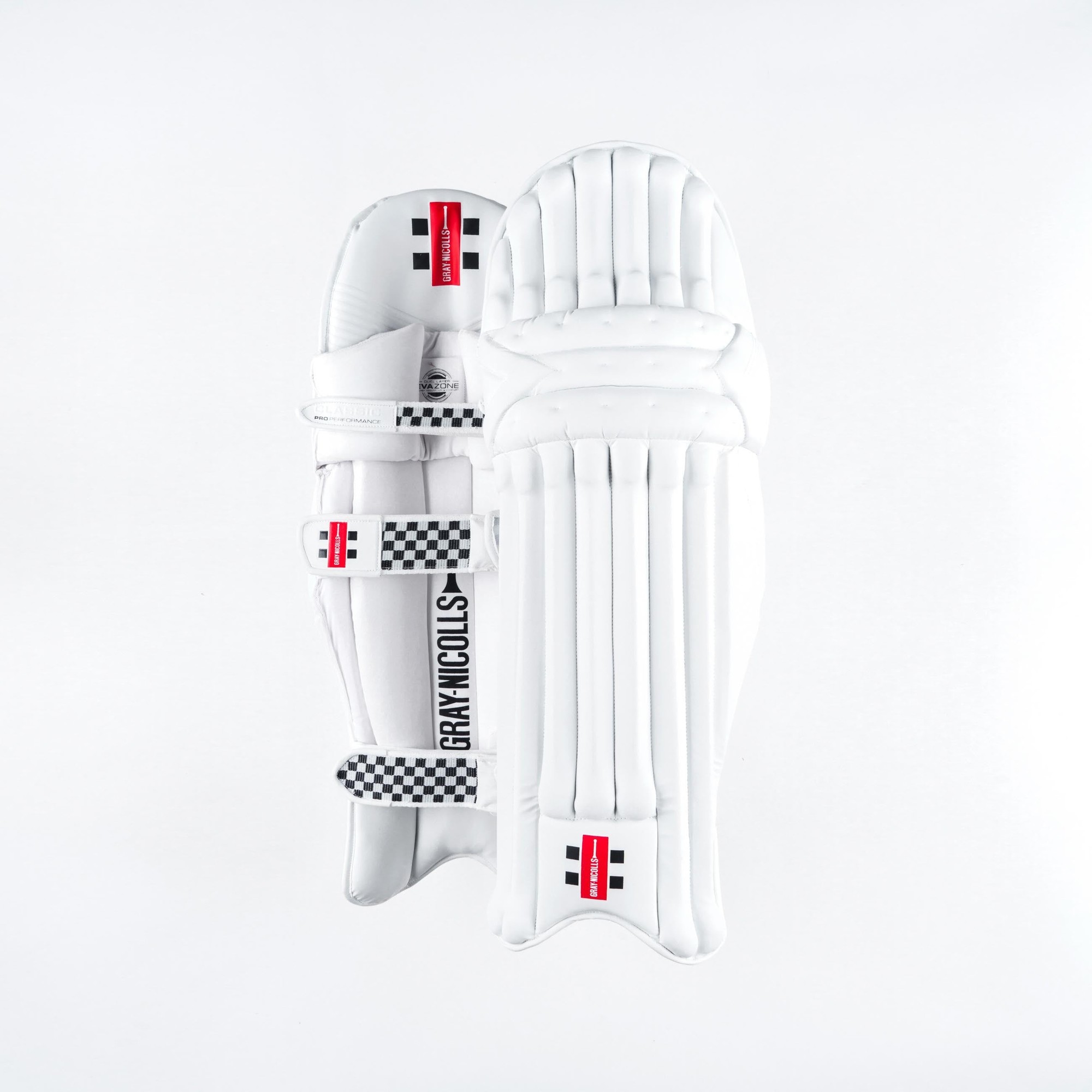 White Gray-Nicolls Classic Pro Performance batting pads featuring a sleek design, padded protection, and adjustable straps with a checkered pattern for enhanced grip.