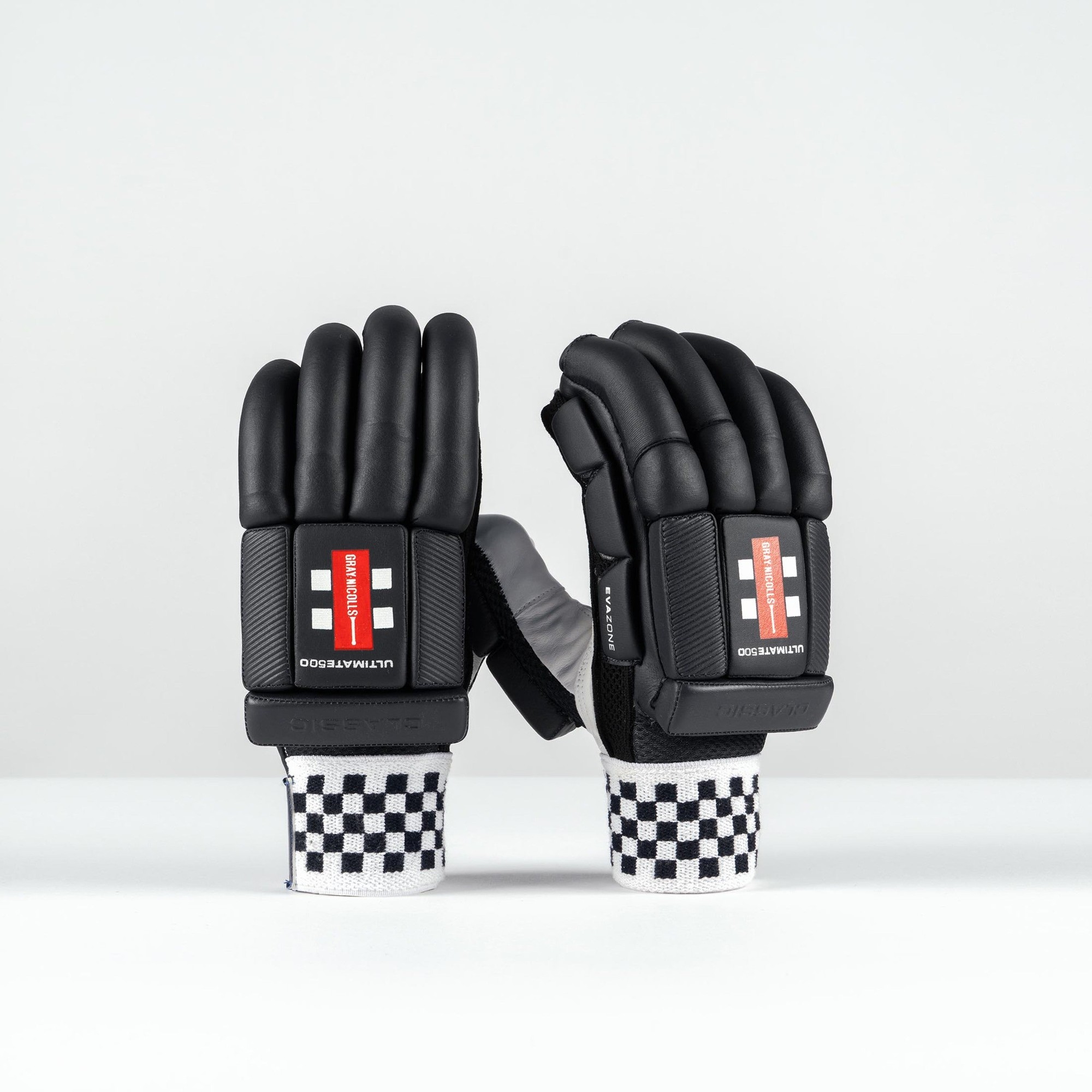 Gray-Nicolls Classic Ultimate 500 adult batting gloves in white, featuring a sleek design, padded black fingers, and a checkered wrist strap for added support.