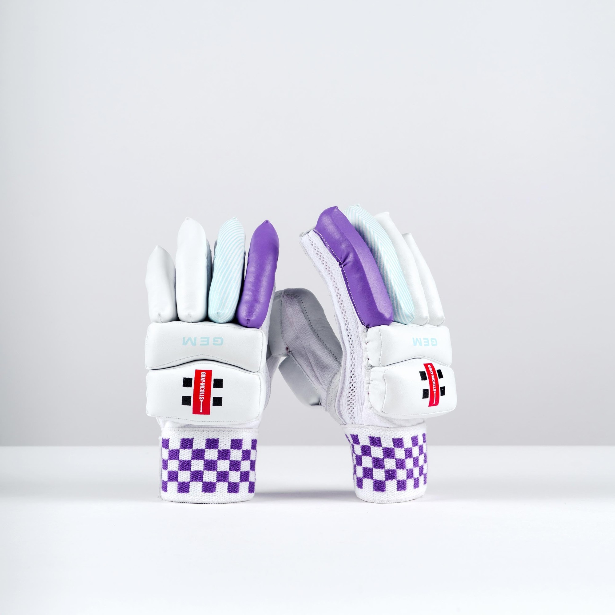 Gray-Nicolls GEM 2.1 Power Batting Gloves in white with purple accents, featuring padded fingers, a textured grip, and a checkered wrist strap for enhanced support.