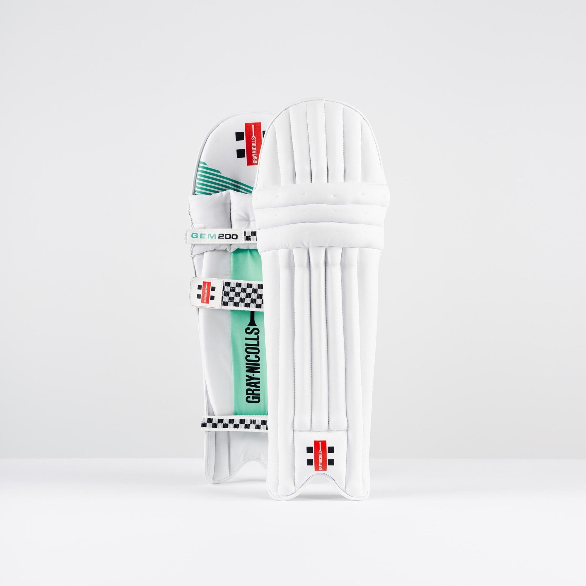 White Gray-Nicolls GEM 3.0 200 batting pads featuring a sleek design with green accents, multiple vertical grooves, and adjustable straps for secure fit.