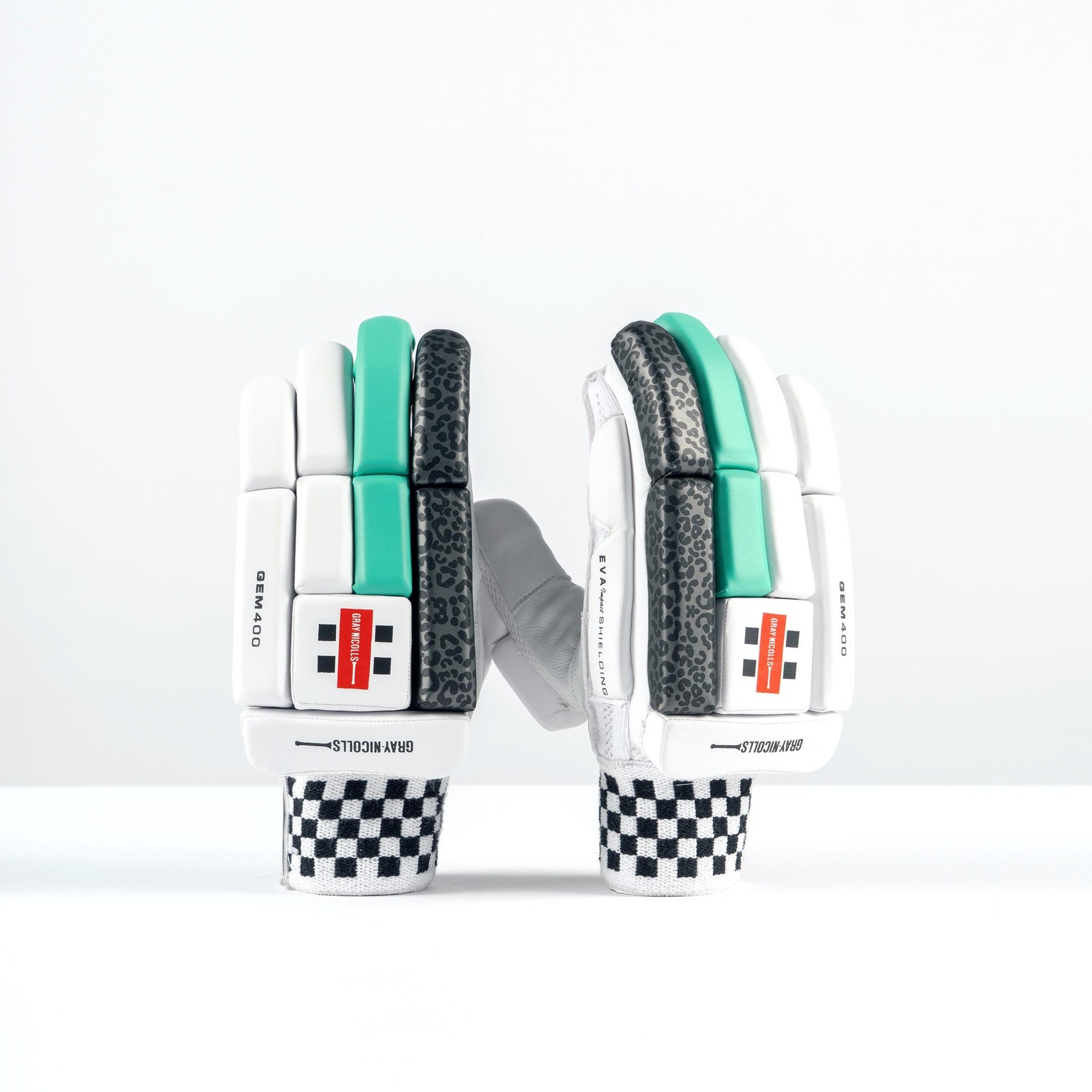 White and teal Gray-Nicolls GEM 3.1 400 women's batting gloves featuring textured palm, padded fingers, and a checkered wrist strap for enhanced grip and protection.