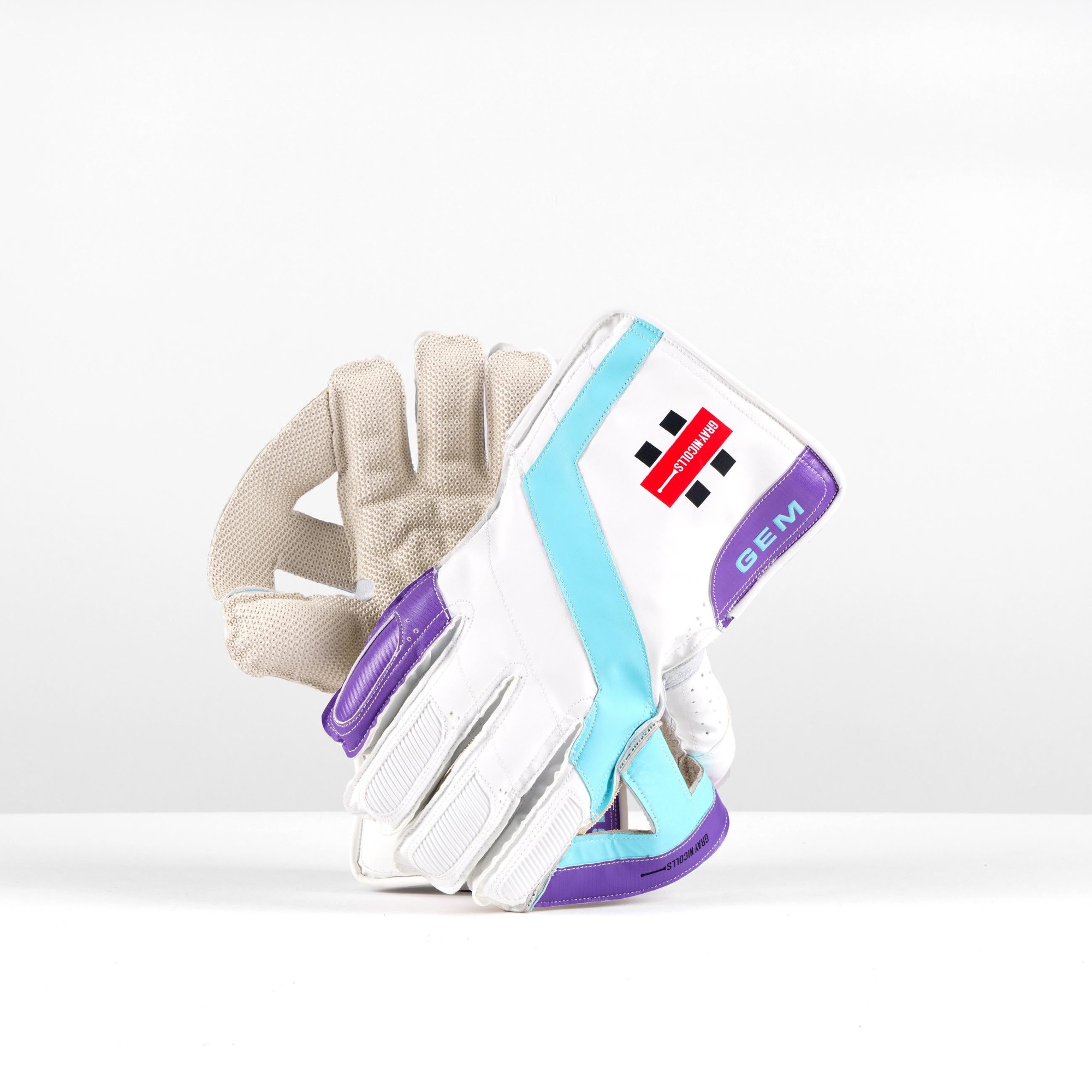 Gray-Nicolls GEM wicketkeeping glove in white, featuring turquoise and purple accents, a textured palm for grip, and a padded back for protection.