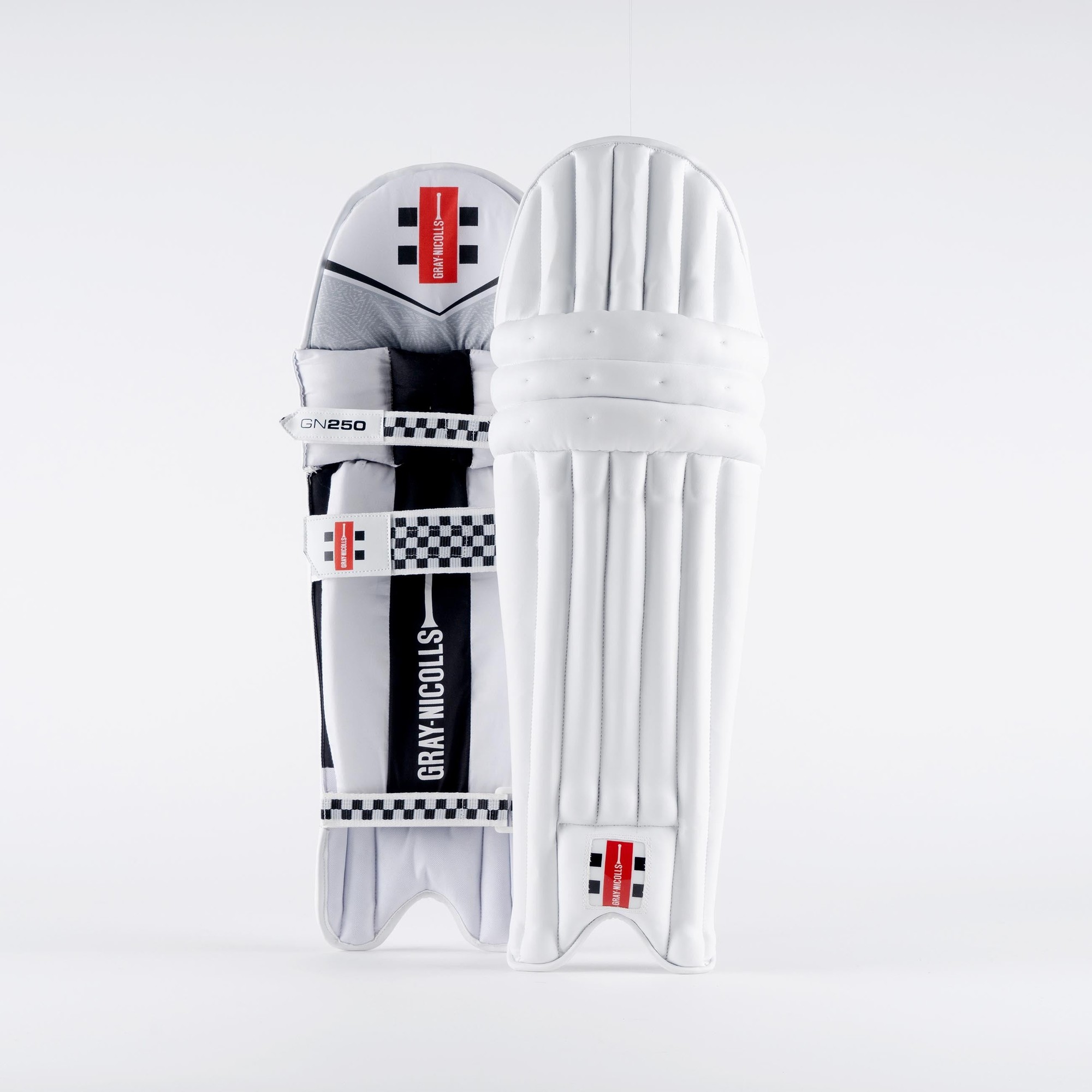 Gray-Nicolls GN250 batting pads in white, featuring a sleek design with black and red accents, padded protection, and adjustable straps for secure fit.