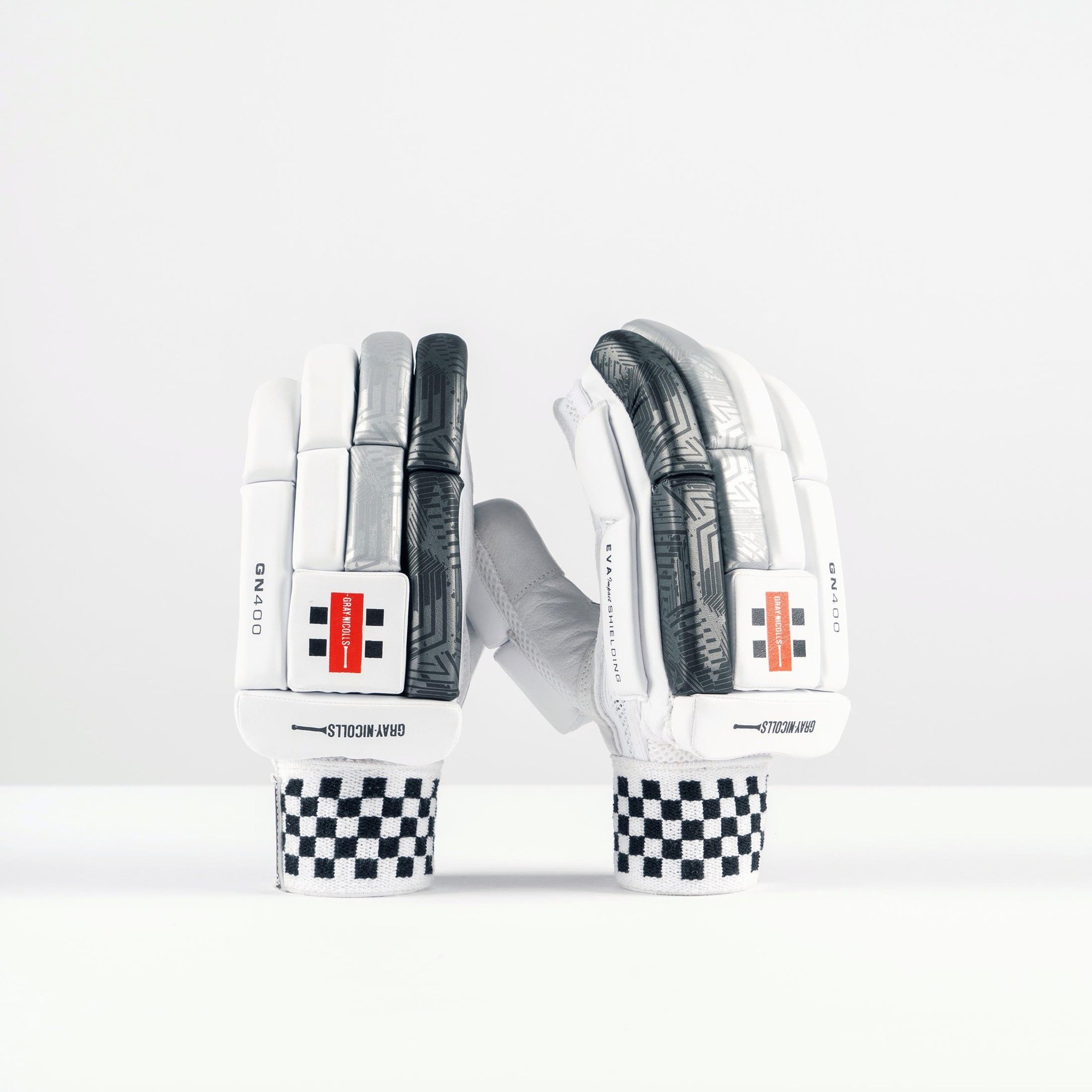 Gray-Nicolls GN400X adult batting gloves in white and gray, featuring a textured palm, padded protection, and a checkered wrist strap for enhanced grip and comfort.