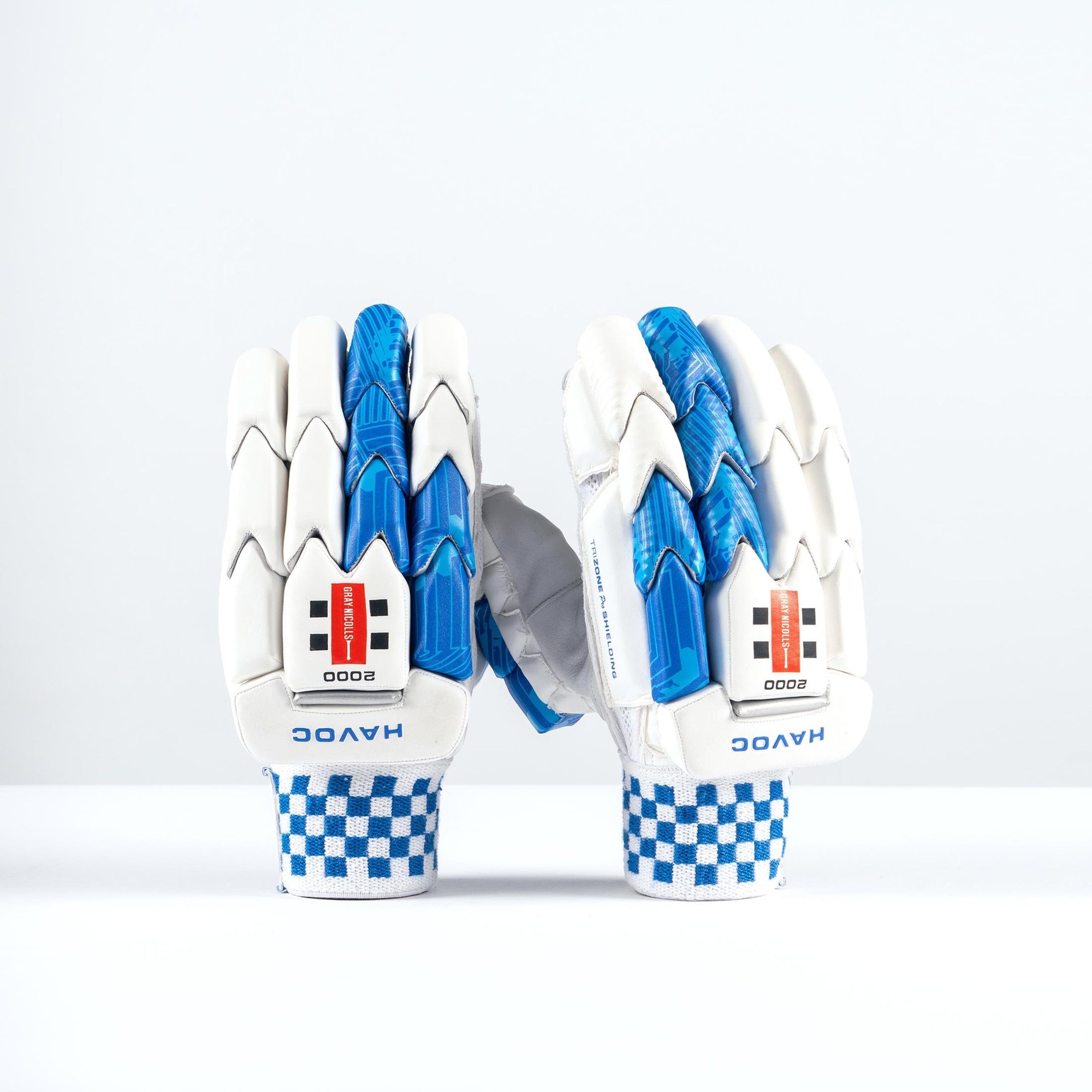 White batting gloves with blue accents, featuring a textured grip, padded protection, and a checkered wristband, labeled "HAVOC" and "2000" on the palms.