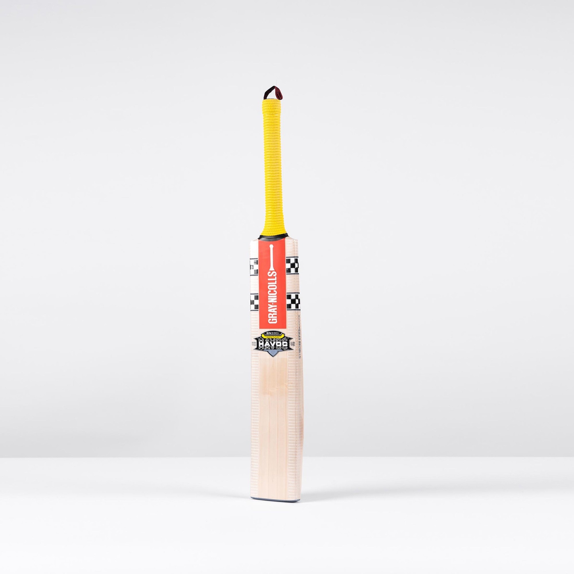 Gray-Nicolls Havoc 1.0 350 Junior cricket bat featuring a light wooden blade, bright yellow grip, and striking red and black branding on the handle.