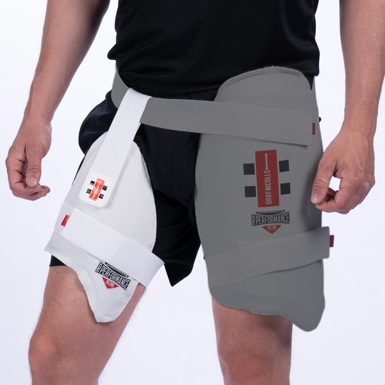 Gray-Nicolls Pro Performance inner thigh pad in white, featuring a padded design and adjustable straps for secure fit, worn on a black athletic short.