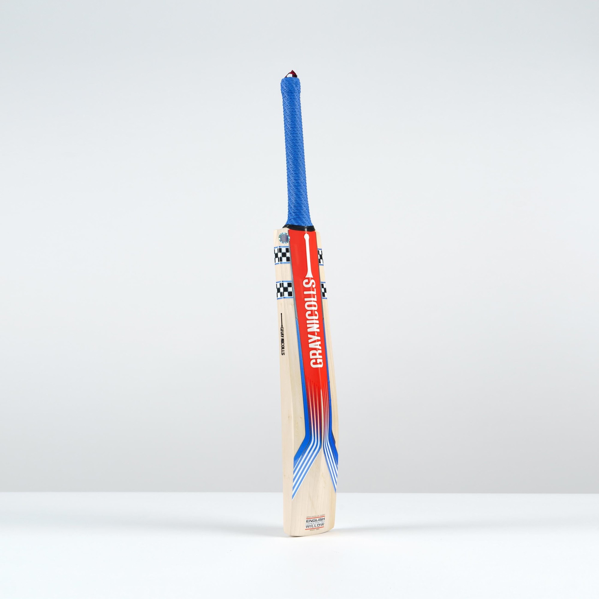 Gray-Nicolls Stratos 1.0 300 cricket bat for juniors, featuring a light wooden body, vibrant red and blue graphics, and a blue textured grip.