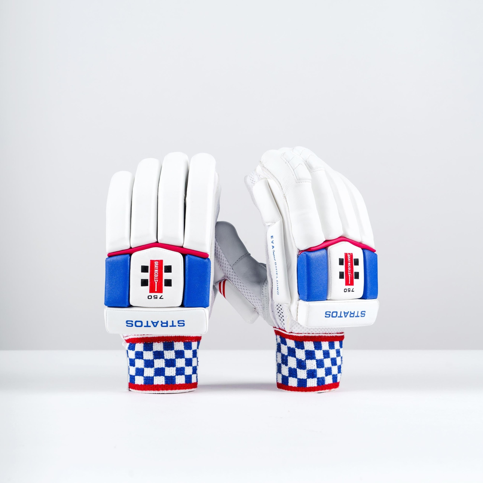 White Gray-Nicolls Stratos 1.0 750 batting gloves featuring blue and red accents, padded protection, and a checkered wrist strap for enhanced grip.