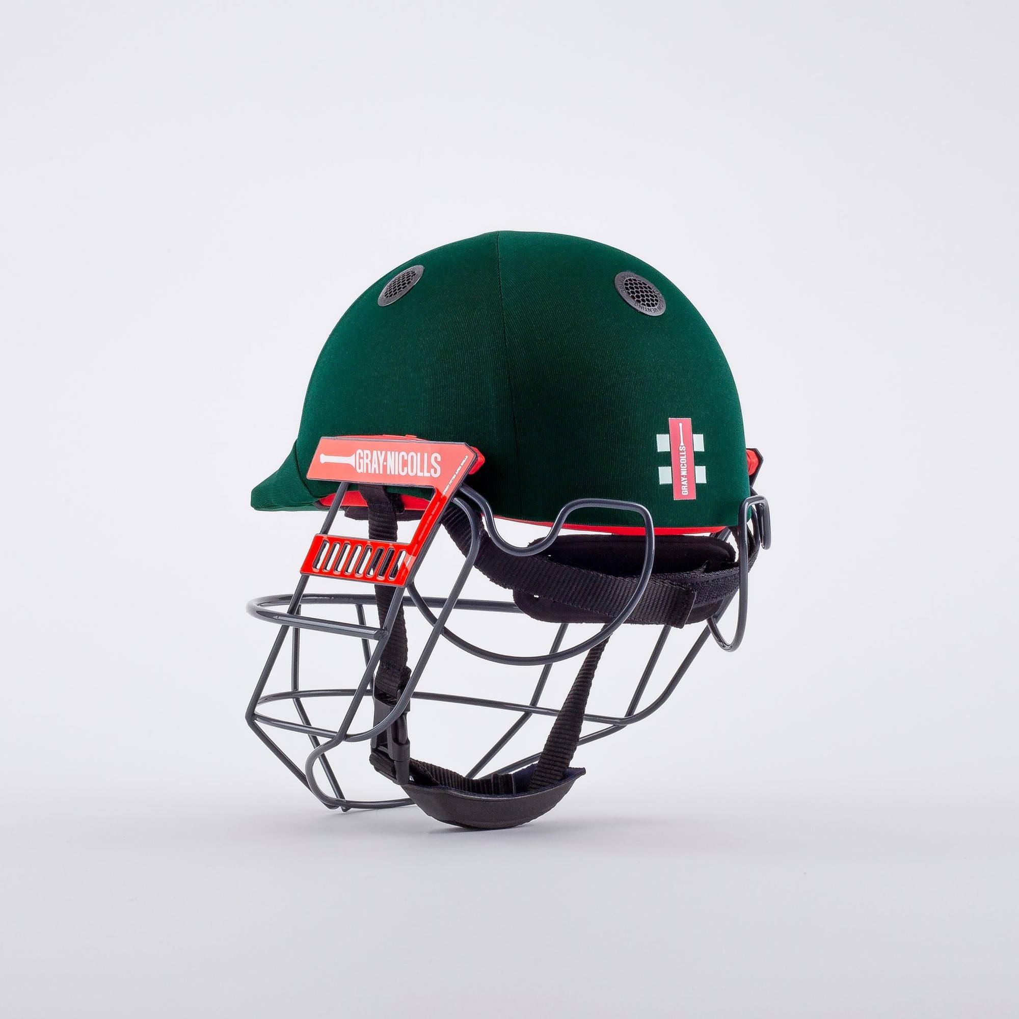 Gray-Nicolls Ultimate 360 Cricket Helmet in dark green with a red grille, featuring ventilation holes and a protective design for enhanced safety.