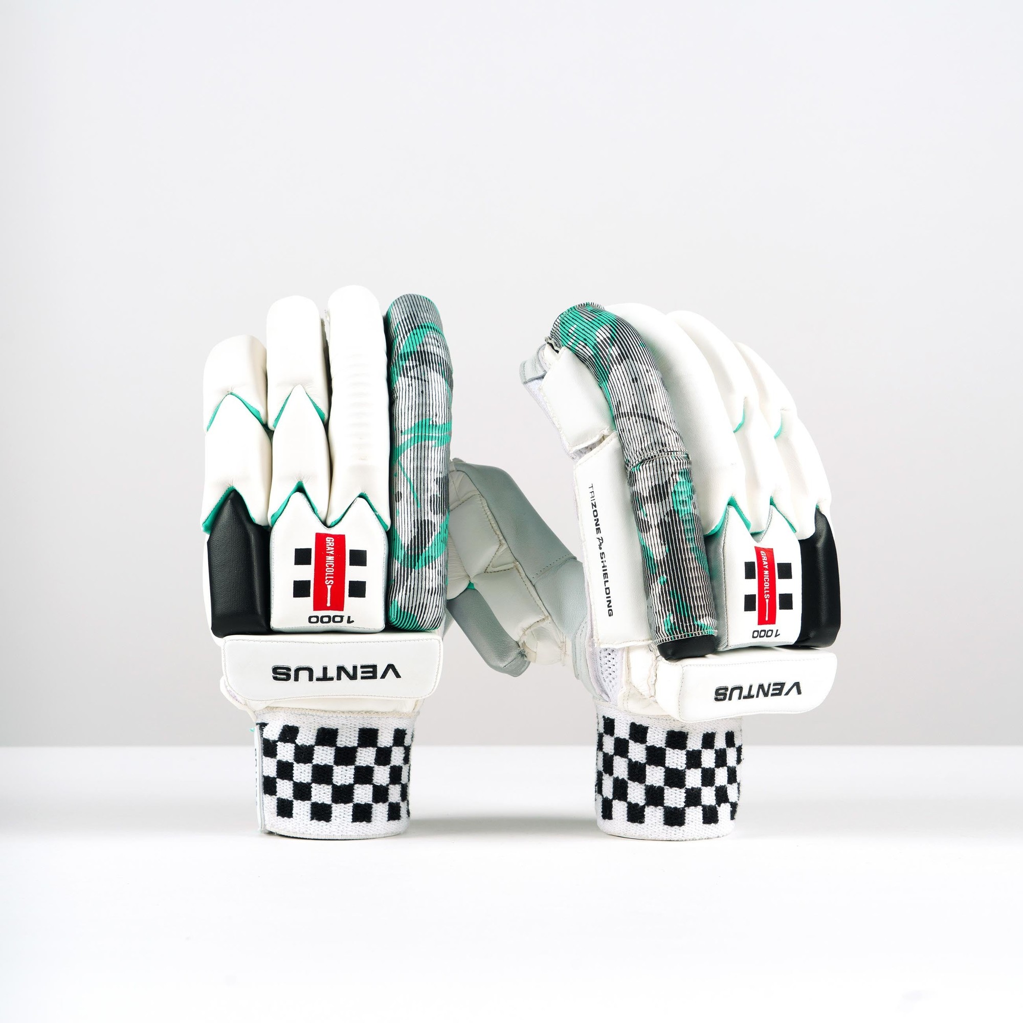 White batting gloves with a gray and green patterned palm, featuring black accents, a checkered wrist strap, and "Ventus 1.0 1000" branding on the back.