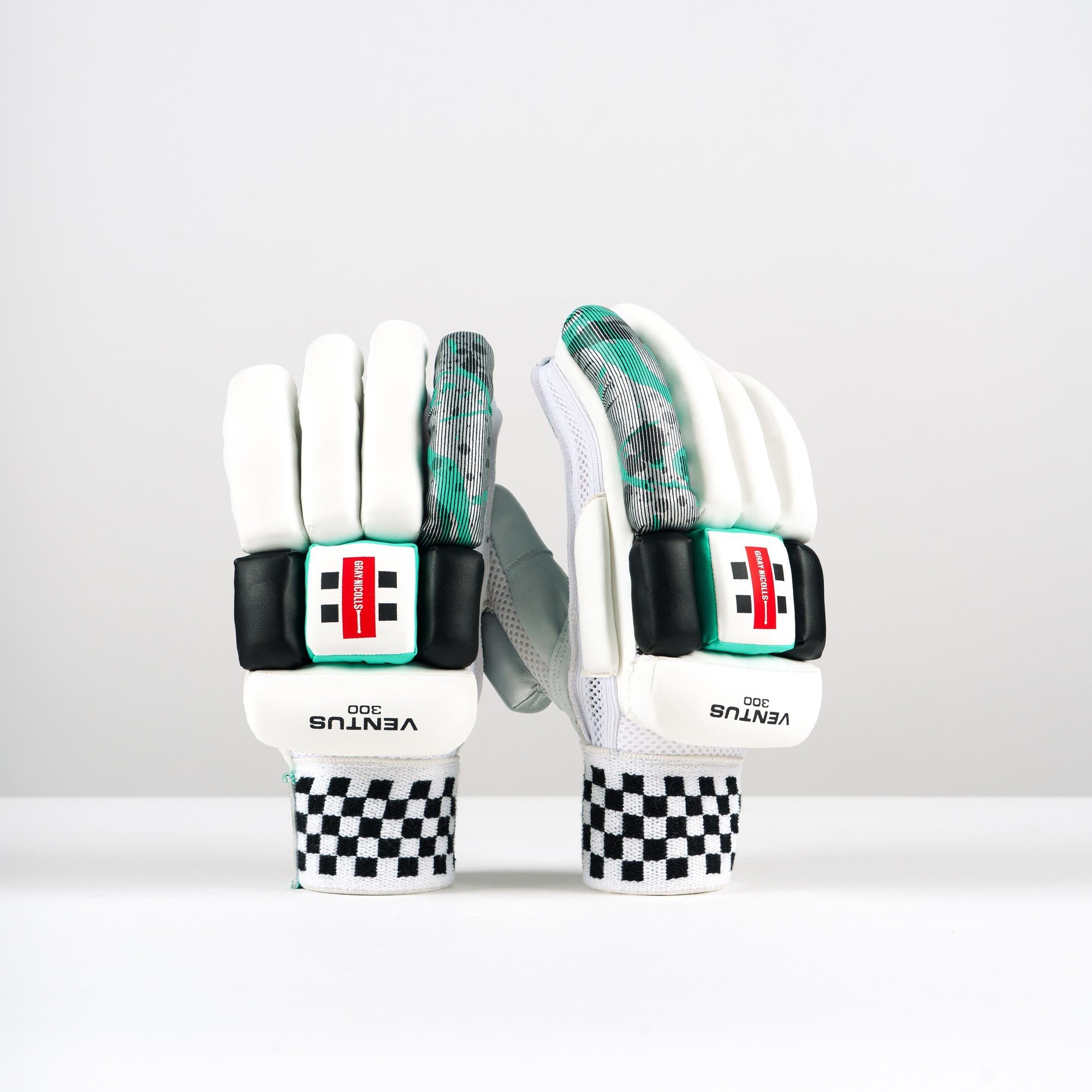 White Gray-Nicolls Ventus 1.0 300 batting gloves featuring a black and white checkered wrist strap, padded palm, and colorful patterned backing for enhanced grip and comfort.