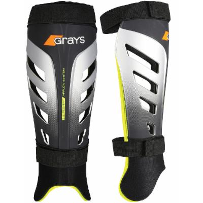 Black and gray Grays G800 shinguards featuring a sleek design with ventilation slots, adjustable straps, and a bright yellow accent along the edges for enhanced visibility.