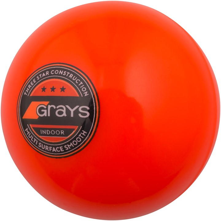 Bright orange indoor hockey ball with a smooth surface, featuring a black circular logo that reads "Grays" and indicates "Three Star Construction."