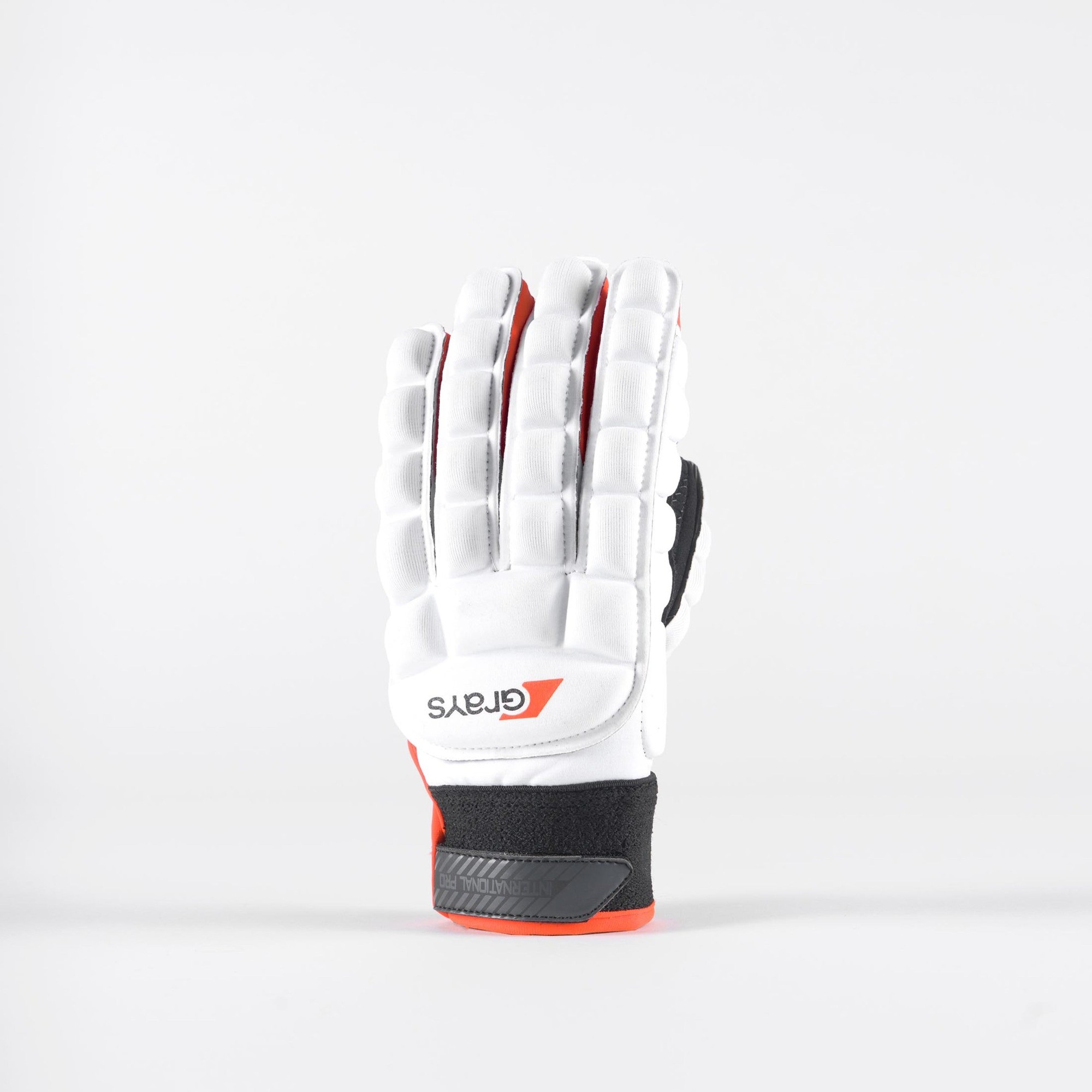 White Grays International Pro Gloves featuring padded protection, a textured grip, and black and red accents for enhanced performance in hockey.