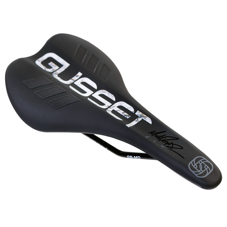 Grey marble-patterned Gusset S2 AM saddle featuring a sleek black base, textured surface, and prominent white "Gusset" logo with a signature.