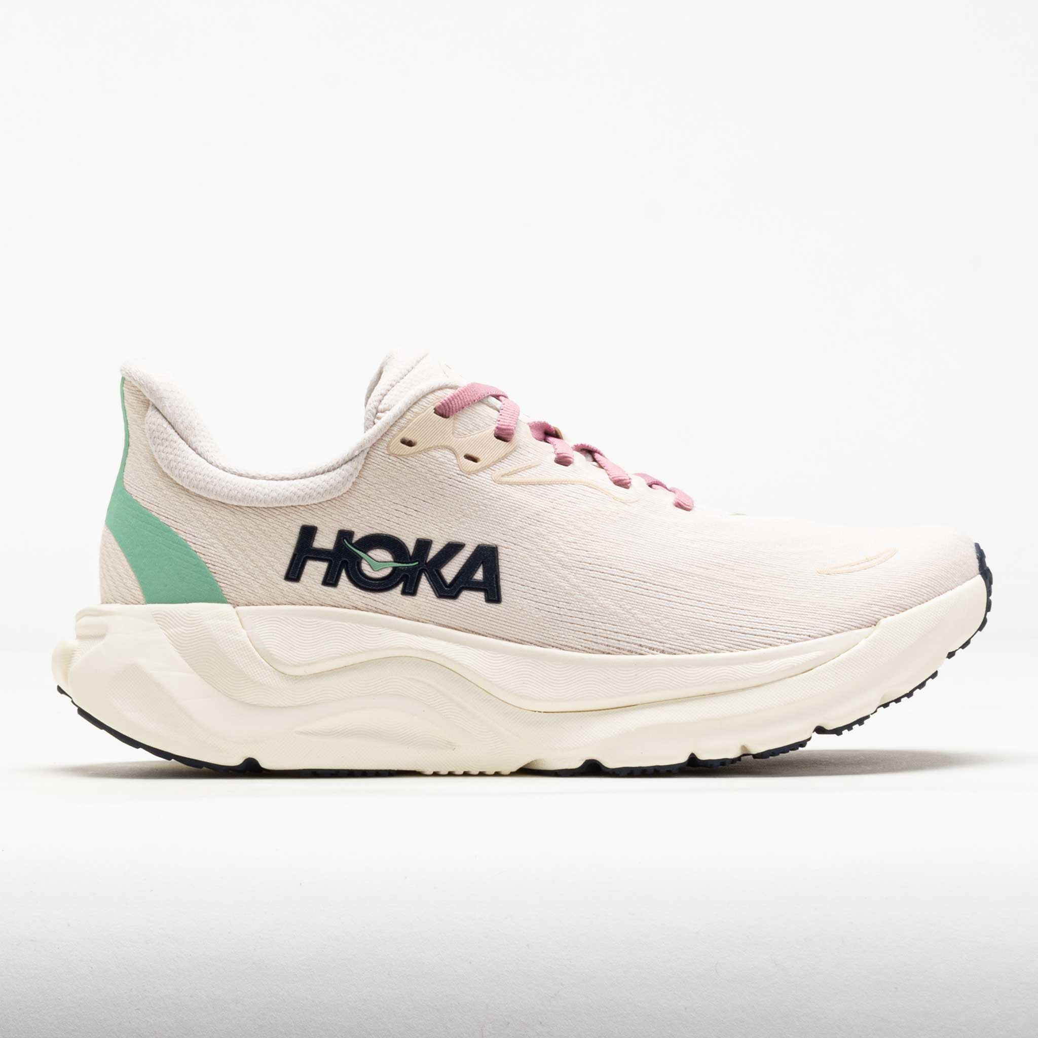 HOKA Women's Arahi 8 road running shoes in rose cream and alabaster, featuring a lightweight design, pink laces, and a green accent on the heel, size 5.5.