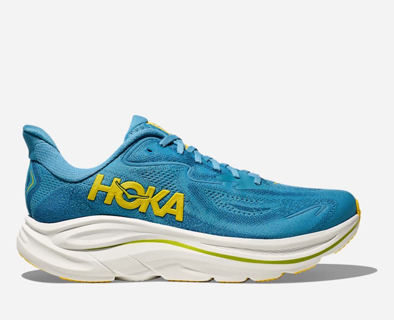 HOKA Men's Clifton 10 running shoes in Alpine Blue and Foggy Night, featuring a breathable mesh upper, cushioned sole, and bright yellow logo, size 6.5.