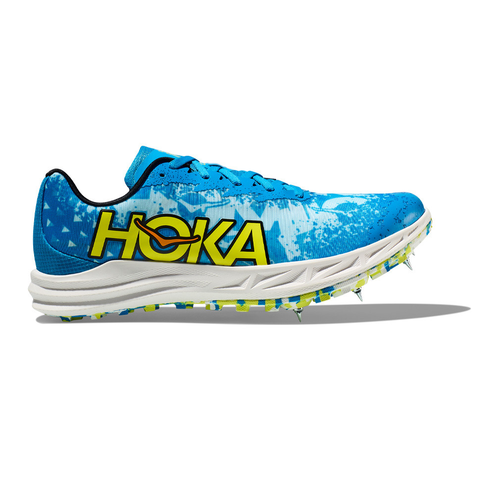 Hoka Crescendo XC unisex running shoe in Dive Blue and Evening Primrose, featuring a vibrant blue upper, yellow logo, and a spiked outsole for traction.