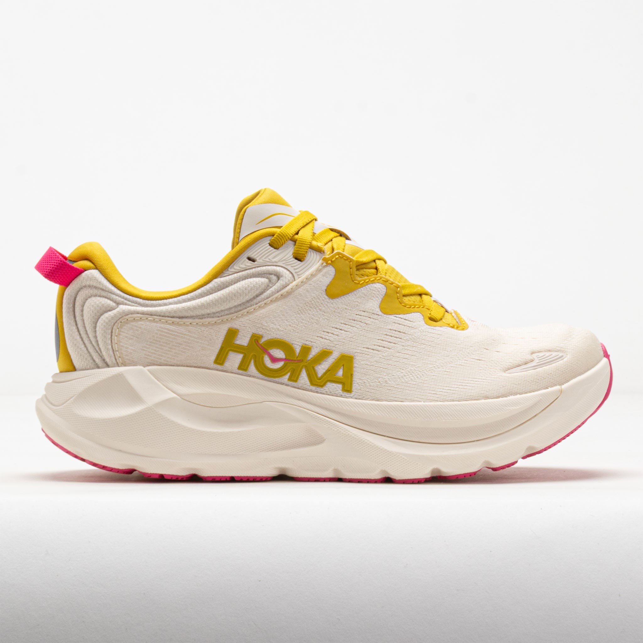 Women's HOKA Gaviota 6 running shoes in Birch and Yellow Gold, featuring a lightweight mesh upper, cushioned sole, and vibrant pink accents on the heel and logo.