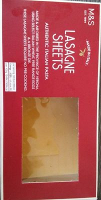 Red packaging with white text labeled "Lasagne Sheets," featuring a clear window displaying flat, golden pasta sheets, emphasizing authenticity and quality.