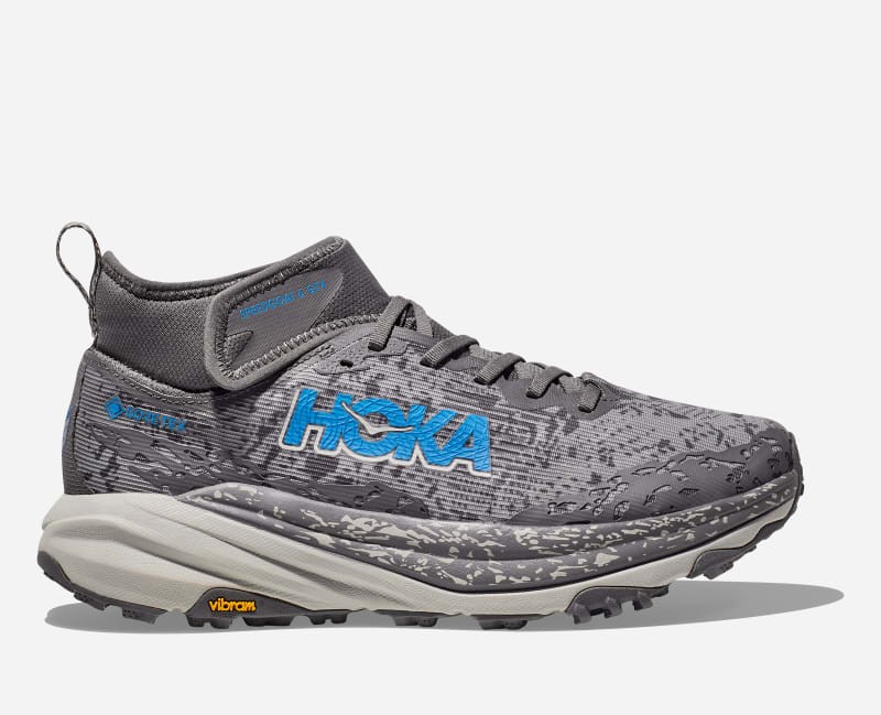 HOKA Men's Speedgoat 6 Mid GTX Shoes in Satellite Grey and Stardust, featuring a textured upper, blue logo, and Vibram outsole, size 13.