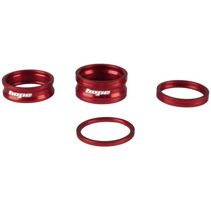 Three red aluminum spacers from the Hope Space Doctor Set, featuring the "Hope" logo on the larger rings, designed for precise bike component adjustments.