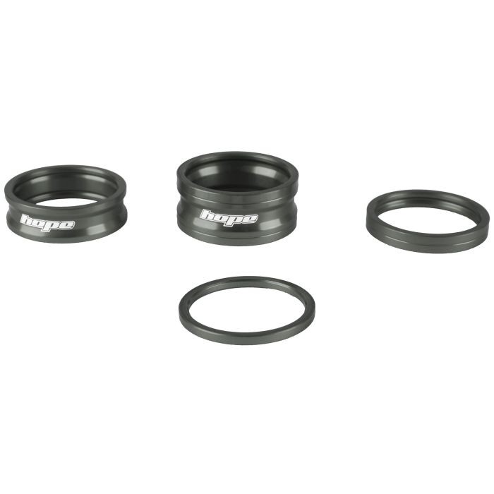 Three black aluminum spacers from the Hope Space Doctor Set, featuring engraved "Hope" branding, designed for precise adjustments in bike components.