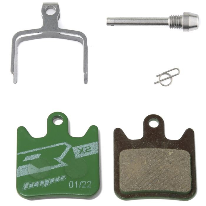 Hope X2 Brake Pads in racing organic grade, featuring green pads with a textured surface, metal components including a silver retaining clip, pin, and spring.