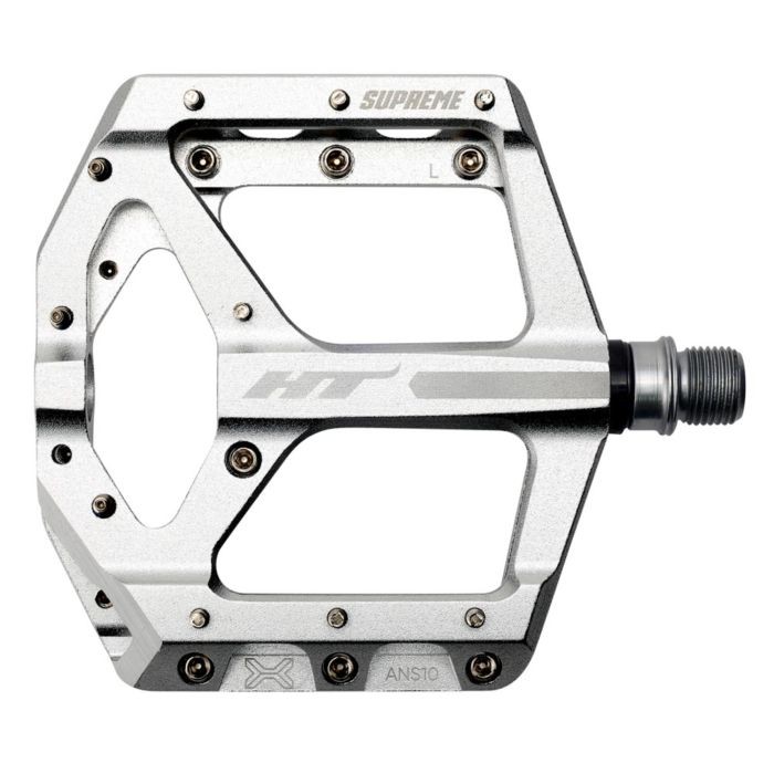 Silver HT Components ANS-10 Supreme pedals feature a robust, lightweight aluminum design with a large platform, multiple grip pins, and engraved branding for enhanced traction and style.