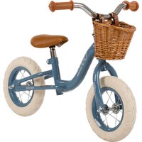 Blue Huffy balance bike with brown seat, wicker basket, white tires, and silver handlebars.