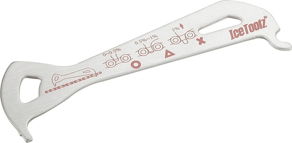 Stainless steel chain checker tool by IceToolz, featuring measurement markings in red for chain wear assessment, with a curved handle for easy grip and use.