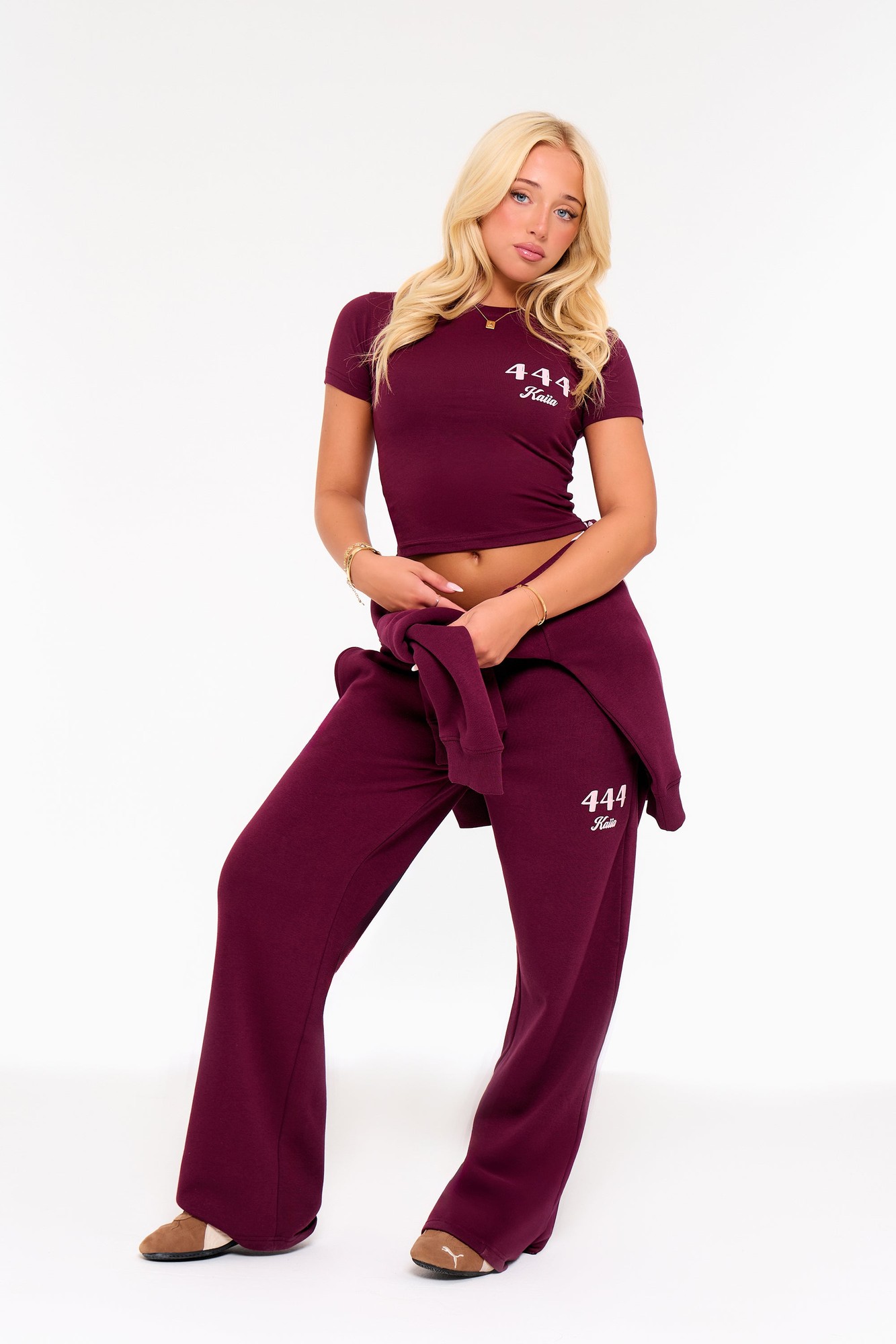 Burgundy wide-leg joggers with pink accents, featuring a comfortable fit and embroidered "444" logo, paired with a matching short-sleeve top for a coordinated look.