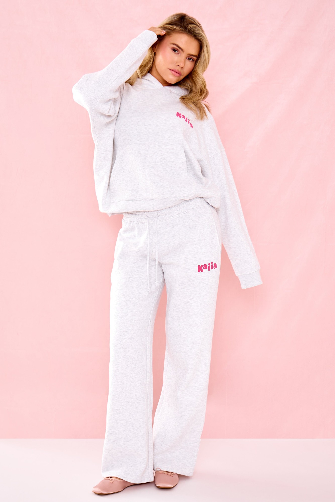 Light grey marl wide leg joggers featuring a pink bubble graphic logo, made from soft material, styled with an elastic waistband for comfort.