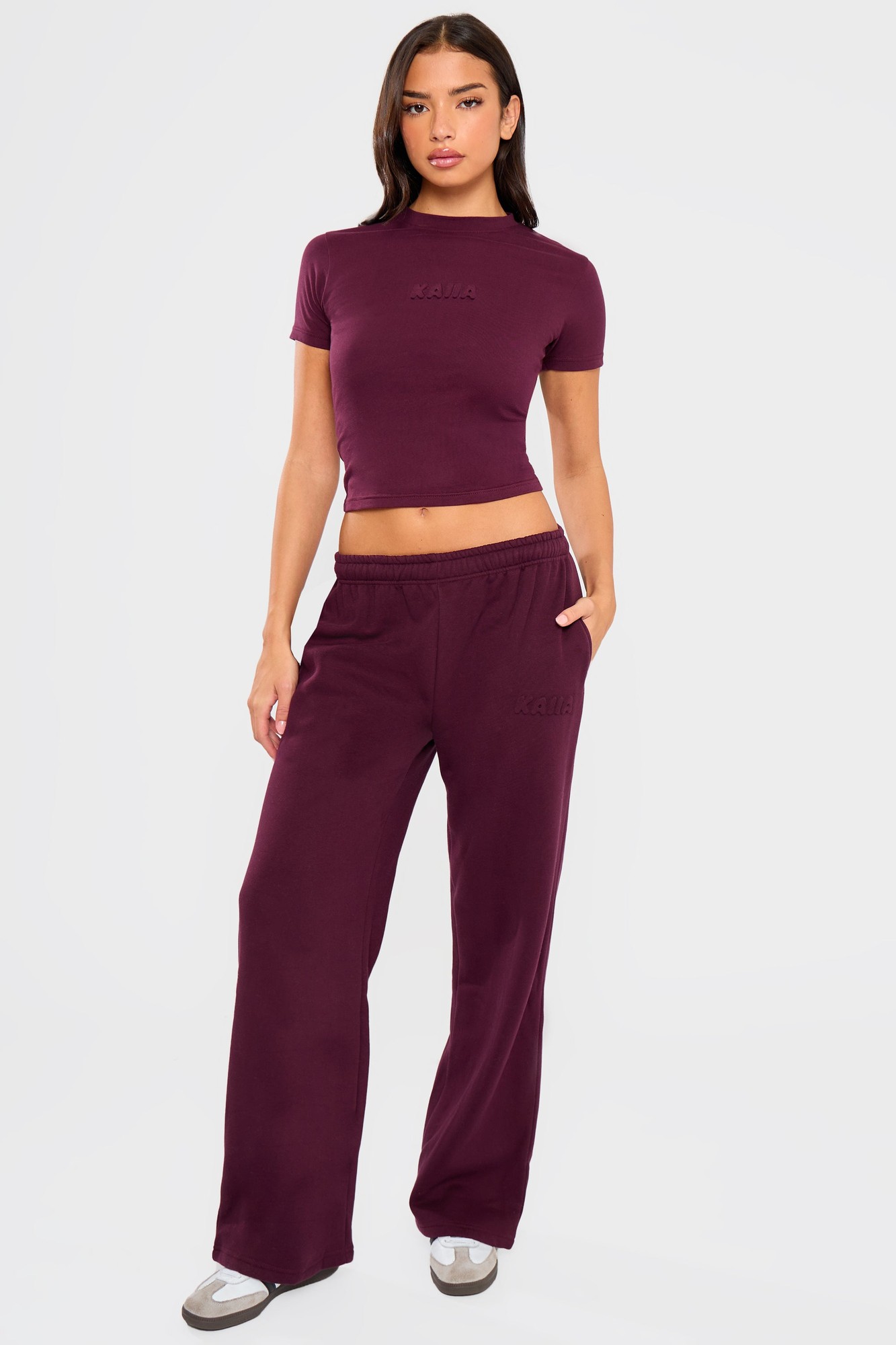 Deep Merlot burgundy wide leg joggers featuring an embossed Kaiia logo, made from soft material, styled with an elastic waistband and side pockets.