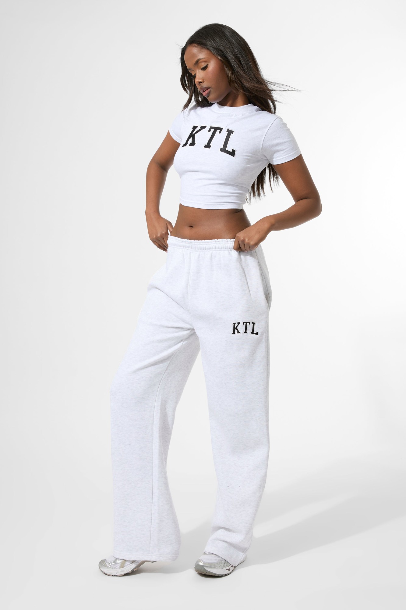Light grey marl wide leg joggers featuring the "KTL" logo on the left hip, made from soft material, styled with a relaxed fit for comfort.