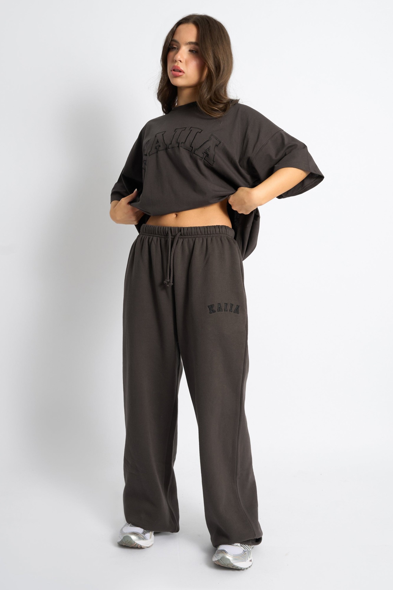 Chocolate brown wide leg joggers made from soft material, featuring an elastic waistband and the "Kaiia" logo printed on the front.