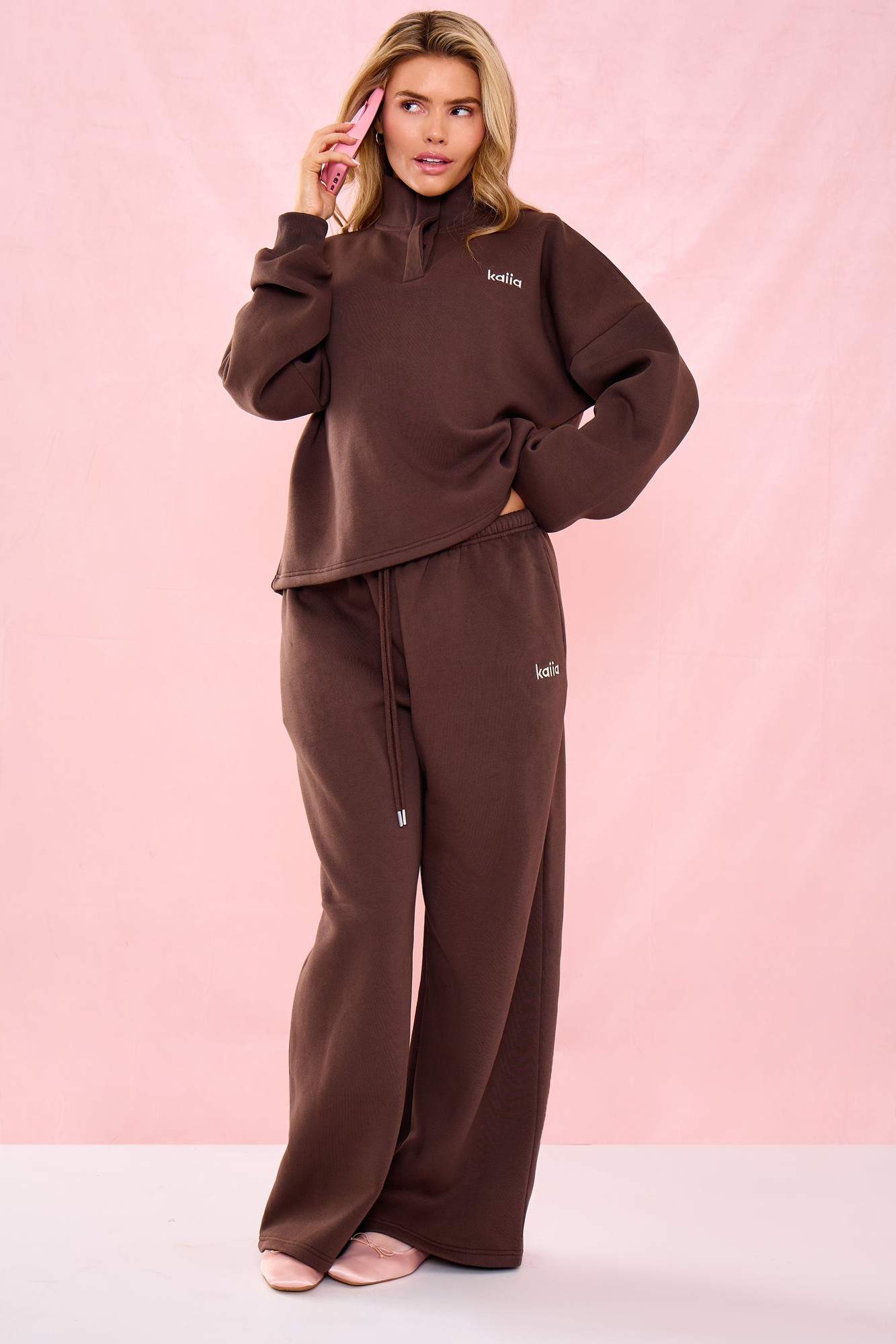 Low rise wide leg joggers in a rich bitter chocolate color, made from soft material, featuring an elastic waistband and subtle branding on the side.
