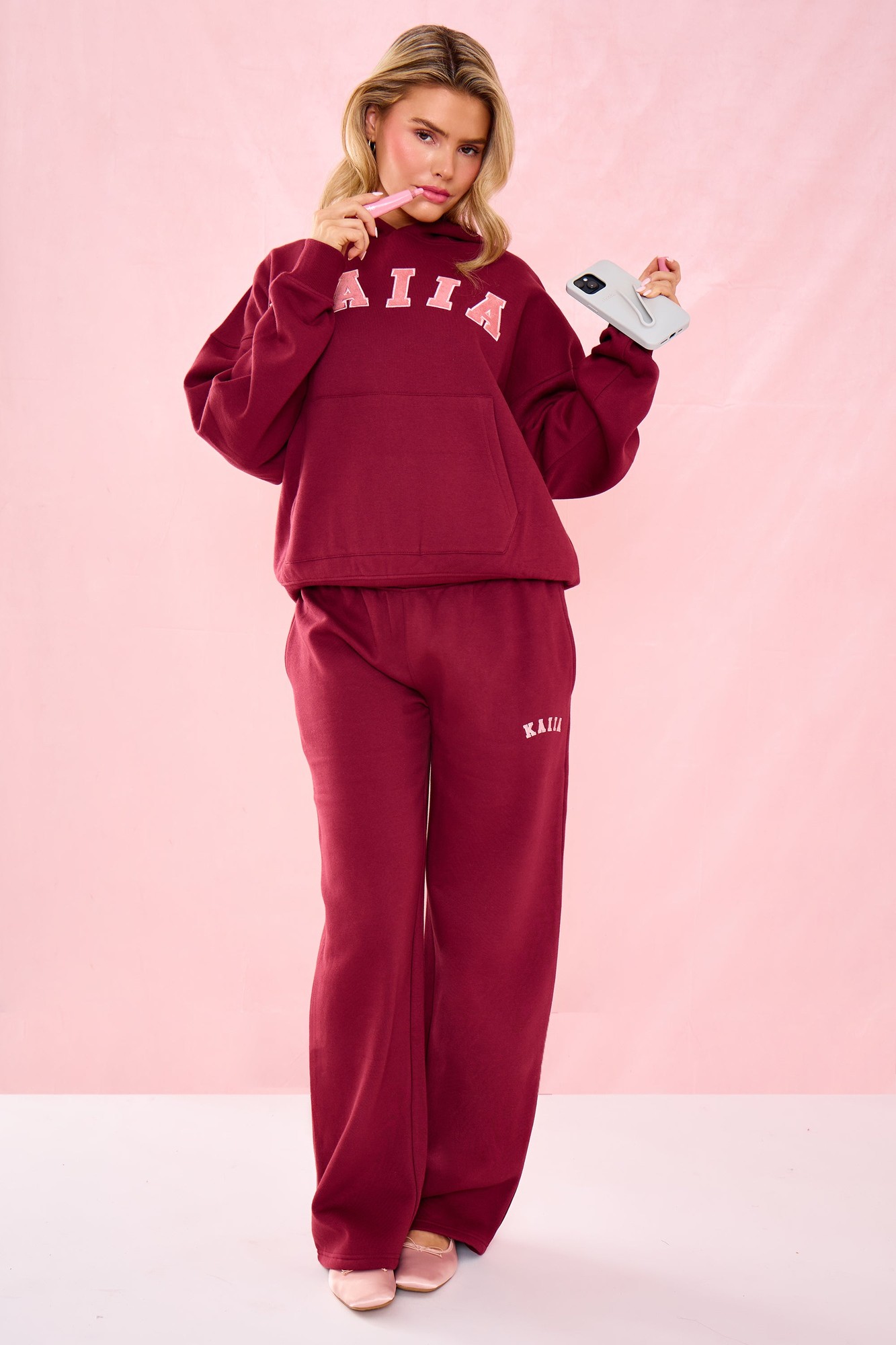 Warm berry mid-rise wide leg joggers made of soft material, featuring a relaxed fit and the brand name "KAIIA" embroidered on the front.