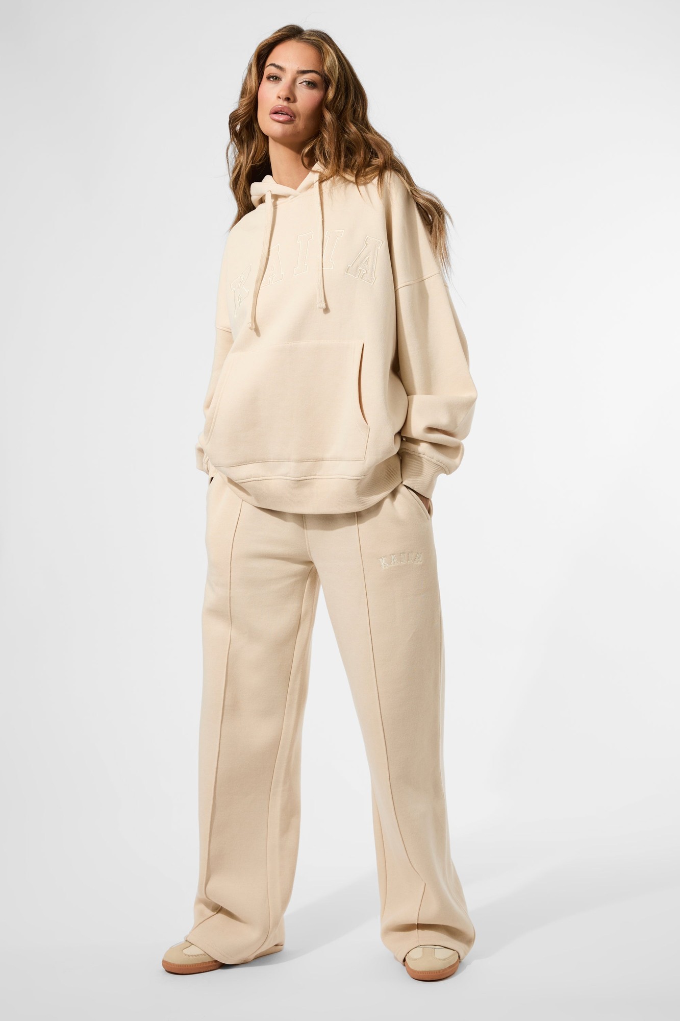 Custard cream wide-leg joggers by Kaiia, featuring seam details, a soft material, and a relaxed fit, paired with a matching oversized hoodie for a coordinated look.