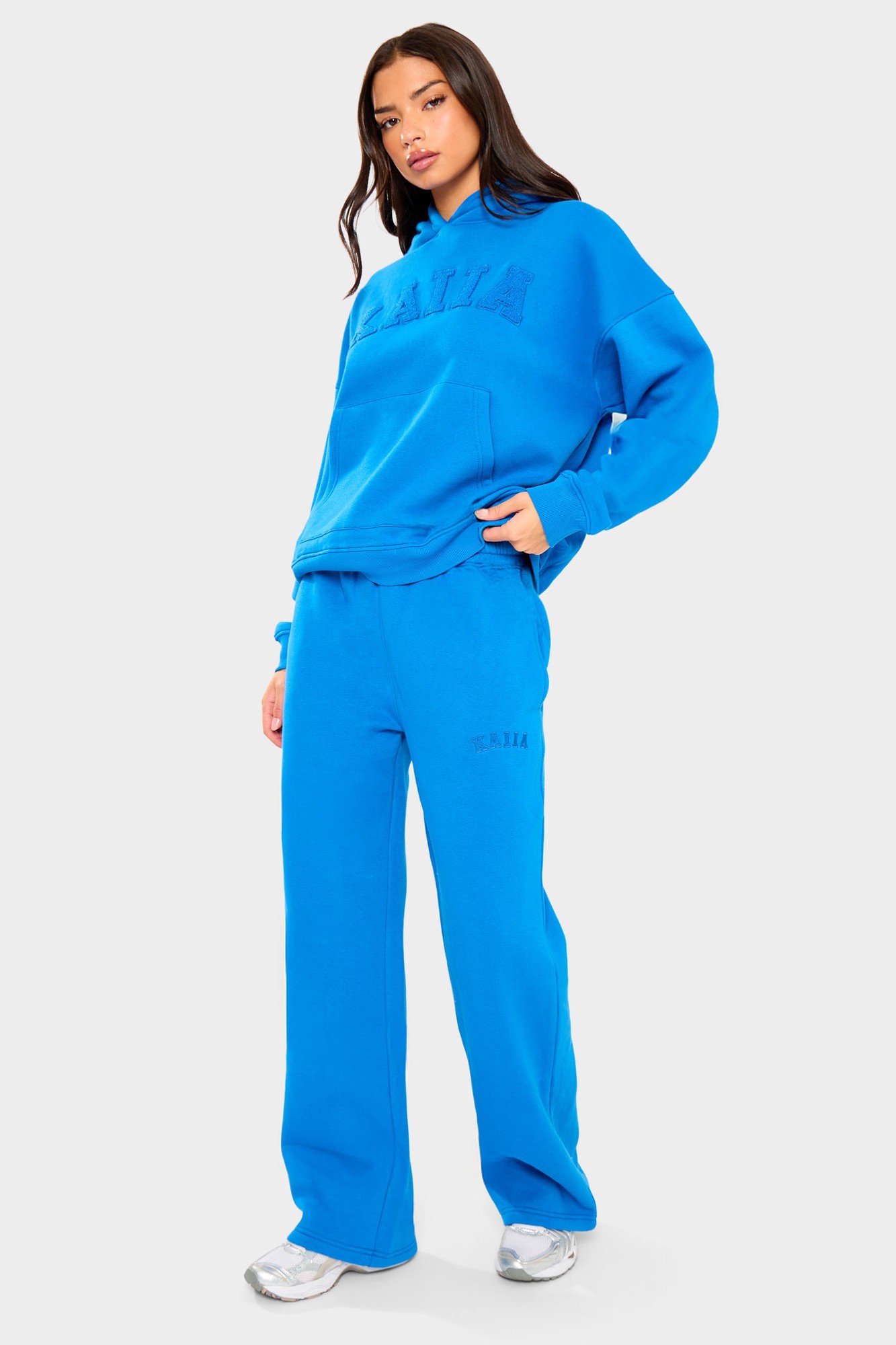 Cobalt blue wide leg joggers made from soft material, featuring an elastic waistband and side pockets, styled with a matching oversized hoodie.