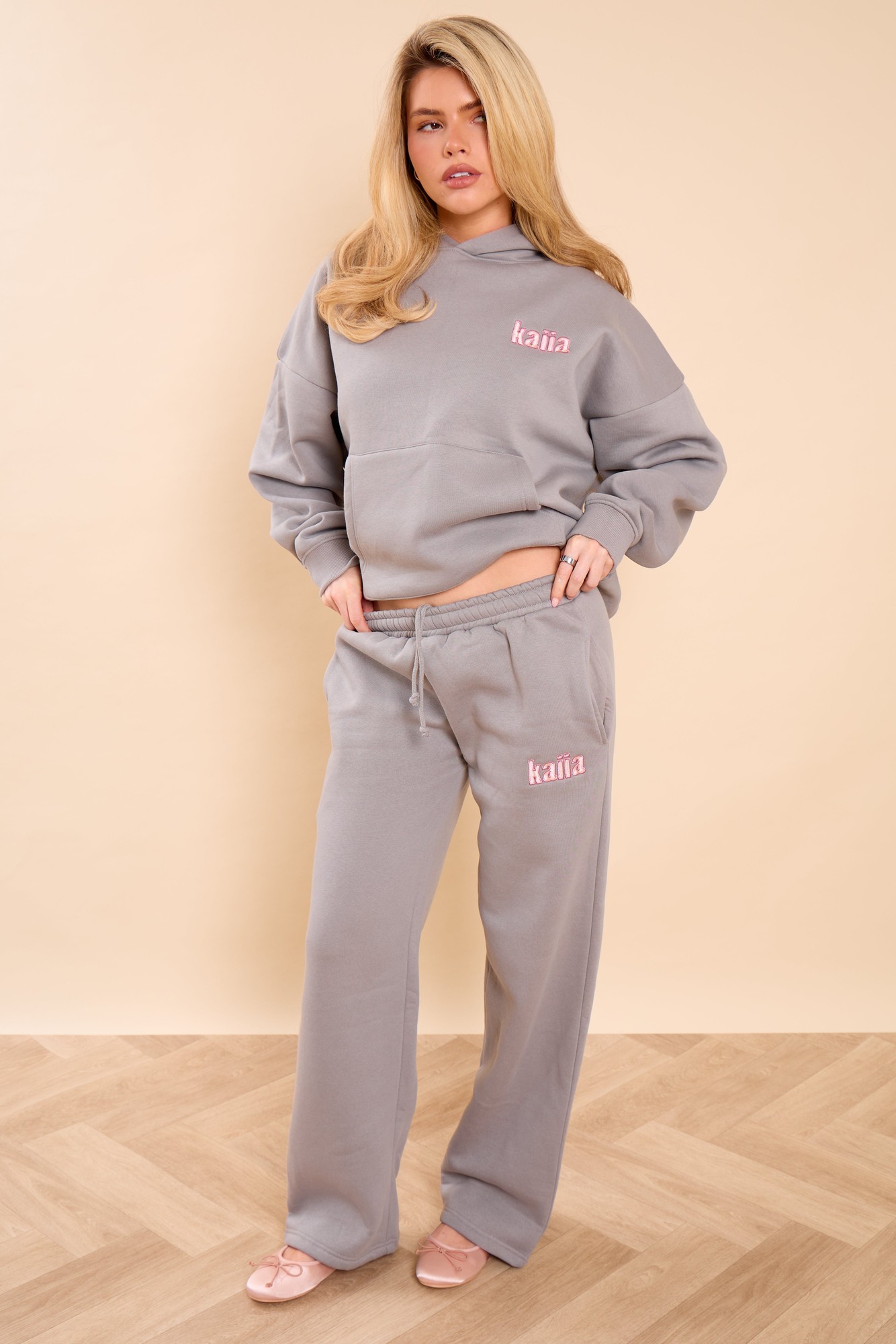 Wide leg joggers in earl grey with pink sugar slogan, featuring a comfortable elastic waistband and soft fabric, styled with a matching sweatshirt.